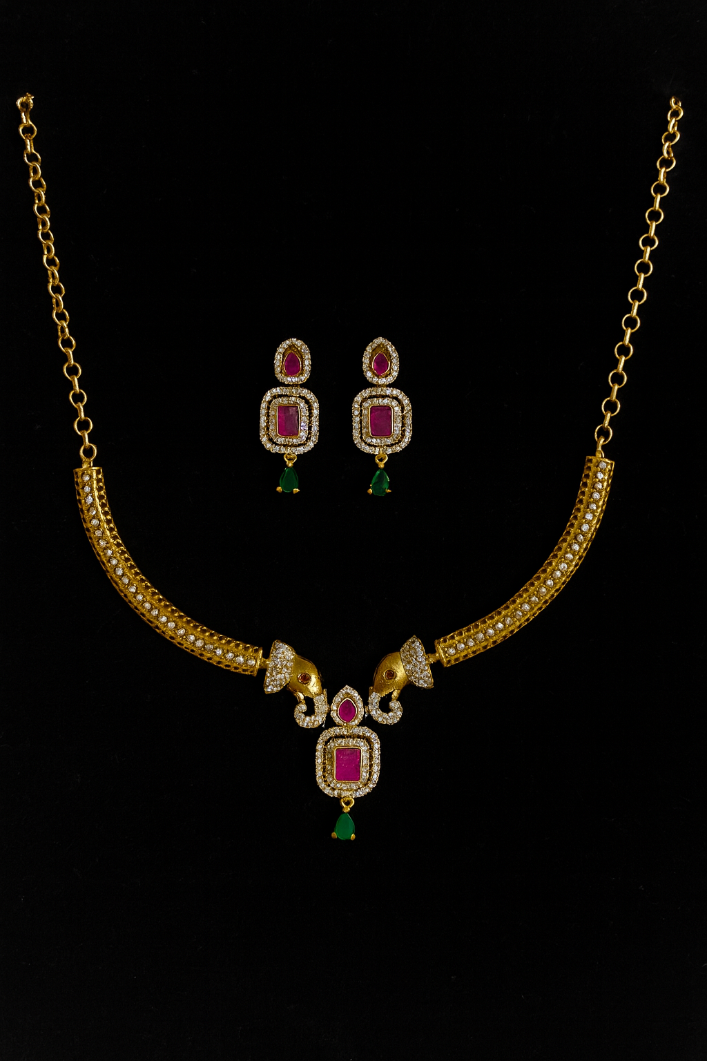 Elegant gold-toned necklace set featuring pink and white stone detailing with a graceful green drop.